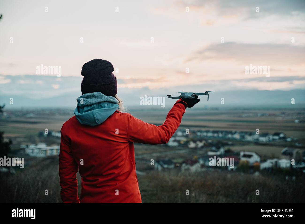 Female person holding a drone ready to take off from her hand Stock Photo