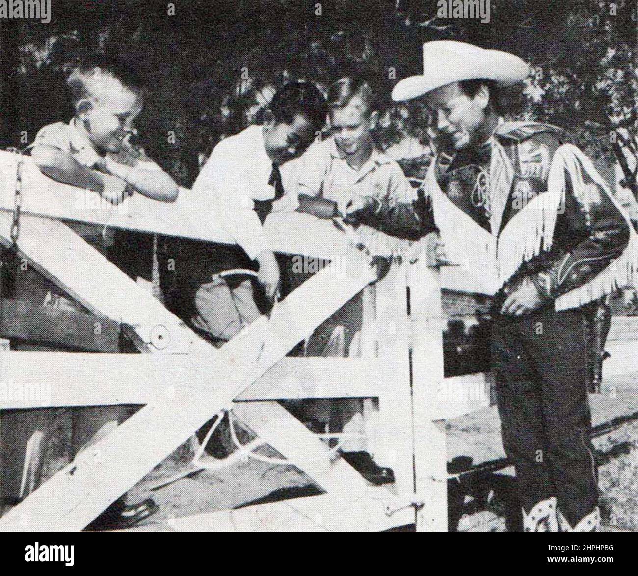 Roy Rogers teaching Guntur Sukarno to use a lasso ca.  1956 Stock Photo
