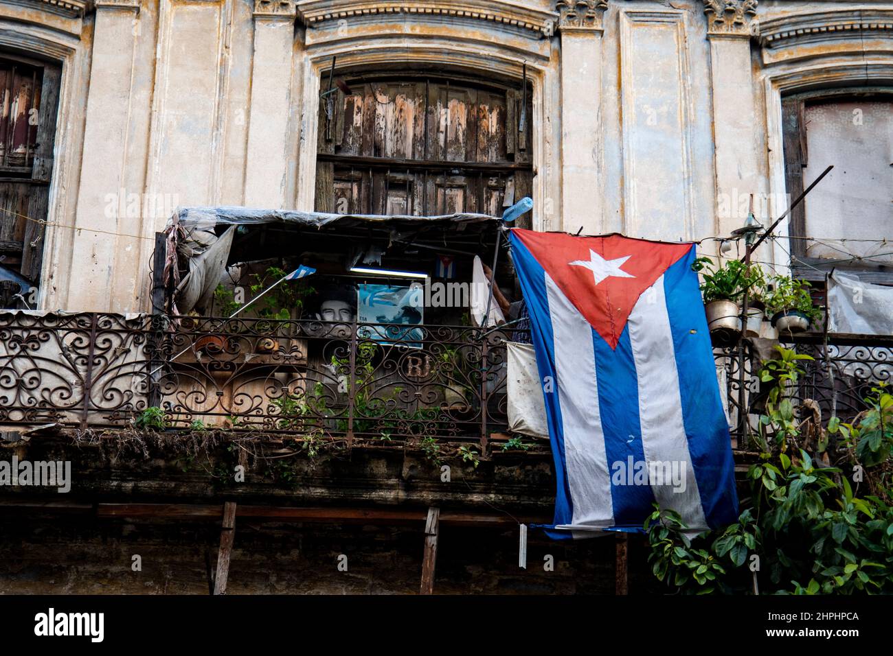 Balcony in Havana, Cuba with pictures of Fidel Castro and a large Cuban flag. Stock Photo