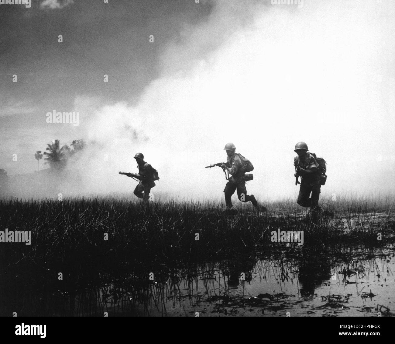 Crack troops of the Vietnamese Army in combat operations against the Communist Viet Cong guerillas. Marshy terrain of the delta country makes their job of rooting out terrorists hazardous and extremely difficult ca.  1961 Stock Photo