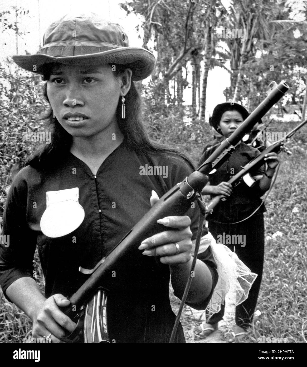 Girl volunteers of the People's Self-Defense Force of Kien Dien, a hamlet of Ben Cat district, 50 kilometeres north of Saigon, patrol the hamlet's perimeter to discourage Viet Cong infiltration. ca.  between circa 1961 and circa 1972 Stock Photo