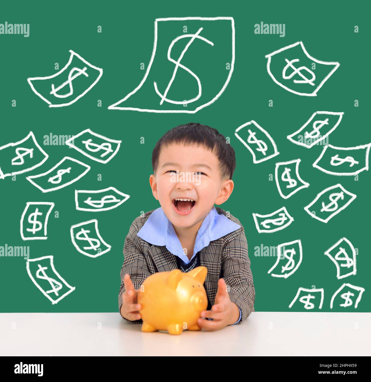 Happy kid holding piggy bank and saving money concept Stock Photo