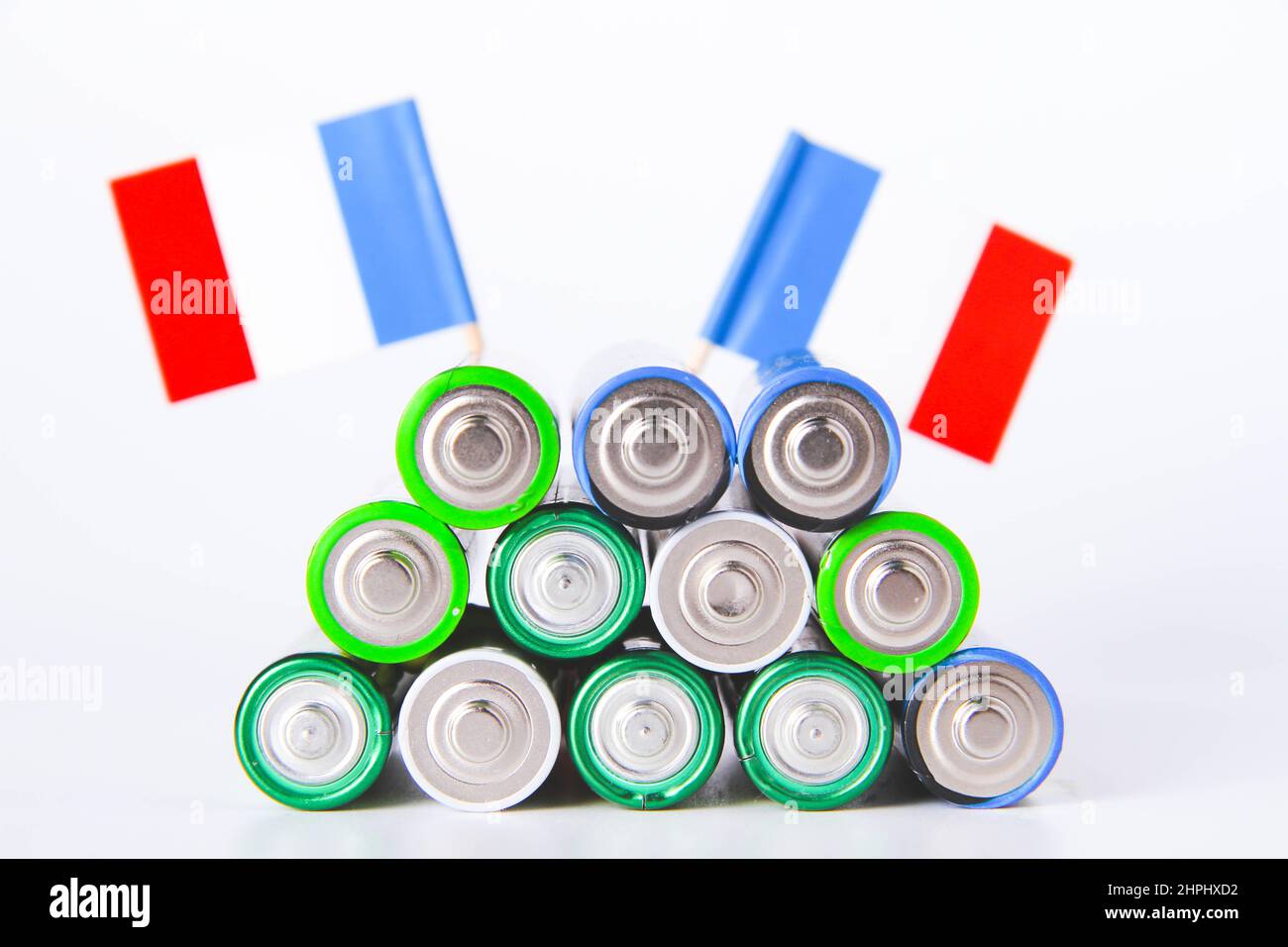 Battery. A lot of batteries on the background of the flag of france. Alkaline and alkaline battery. Zinc and salt battery. Lithium import. Waste dispo Stock Photo