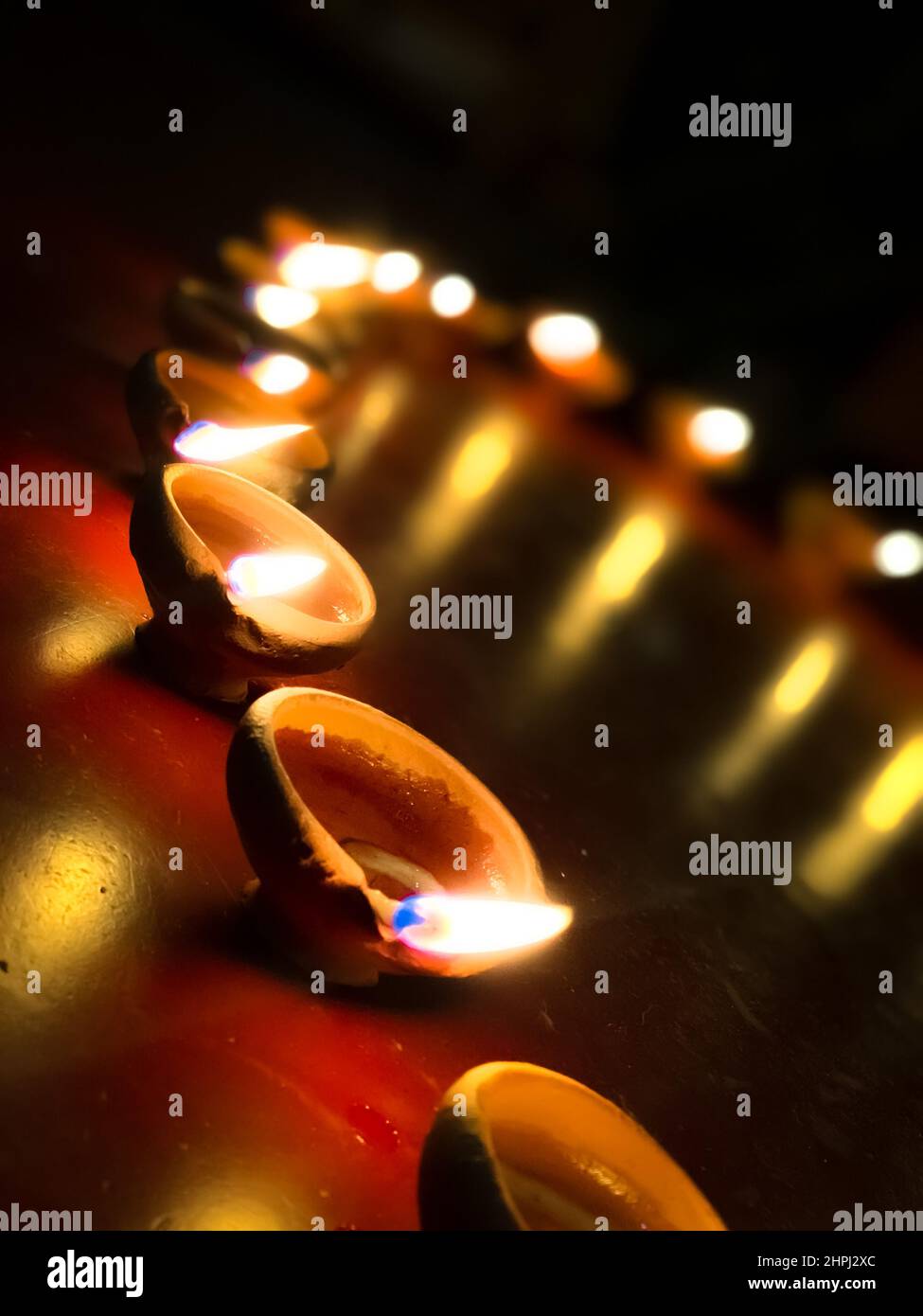 Vertical closeup of the circle of candles burning in the darkness Stock