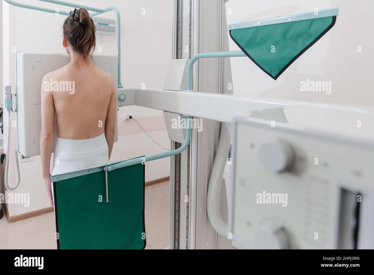 Hospital Radiology Room. Xray machine for fluorography. Woman patient scanning chest, heart or lungs in clinic office. Adult female undergoes Stock Photo