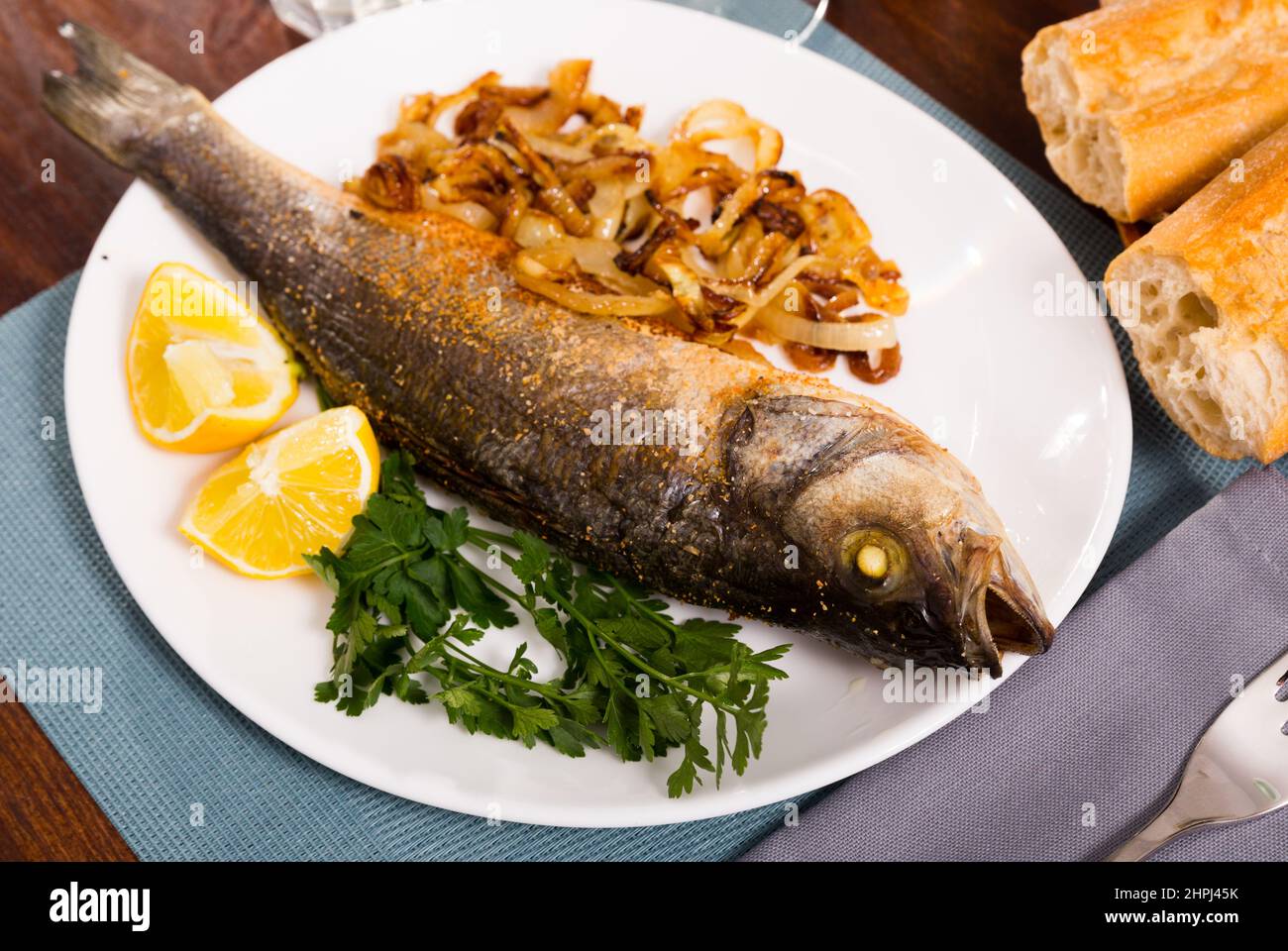 Oven baked sea bass fish Stock Photo Alamy