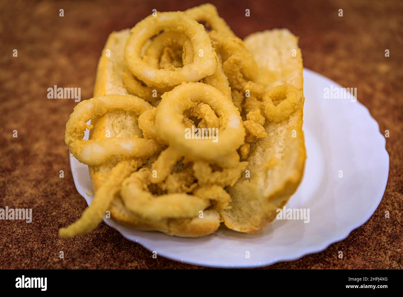 Traditional Spanish fried calamari sandwich served in a restaurant in