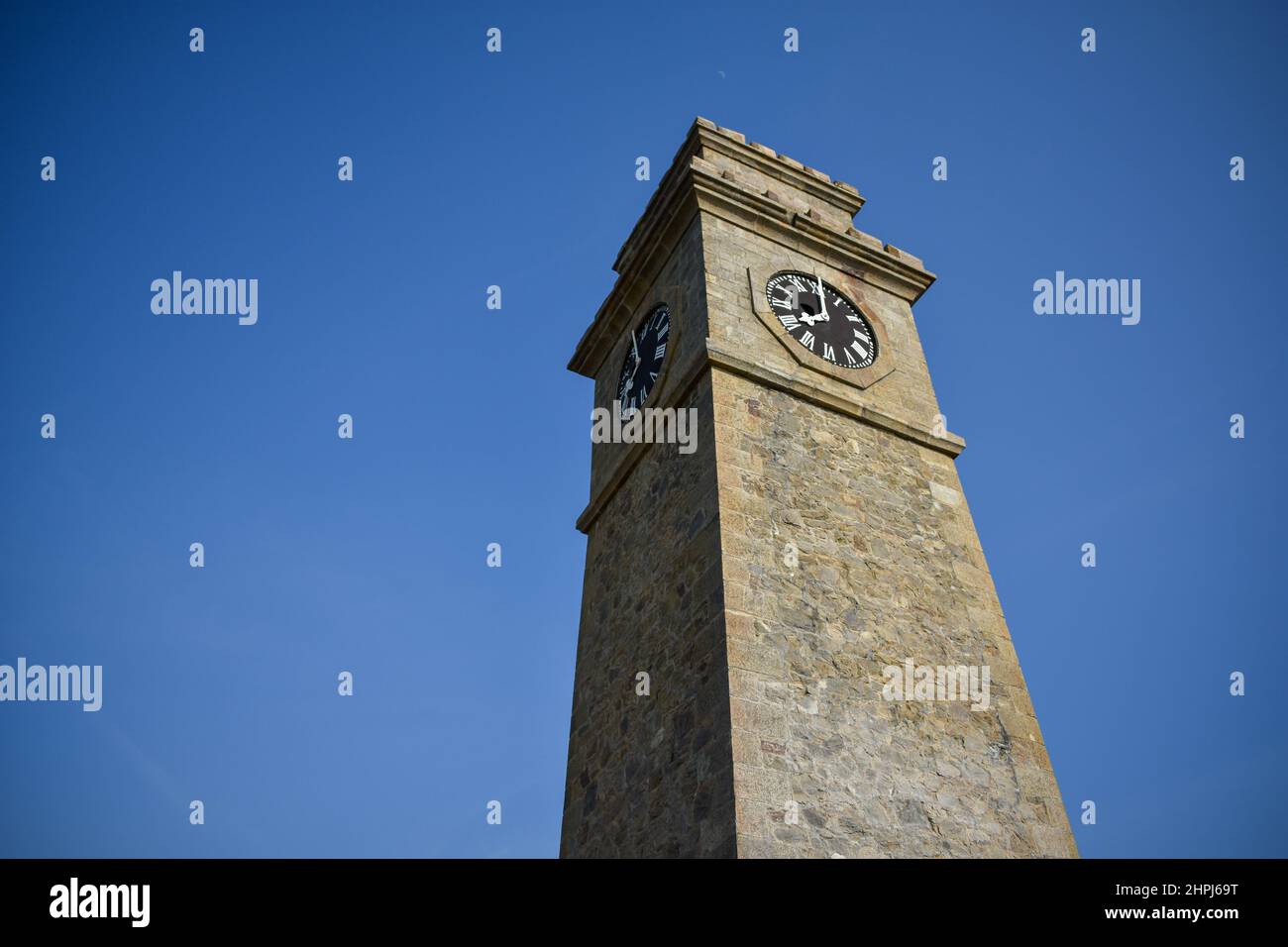 Low angle of a clock tower under the blue sky in Sri Lanka Stock Photo ...