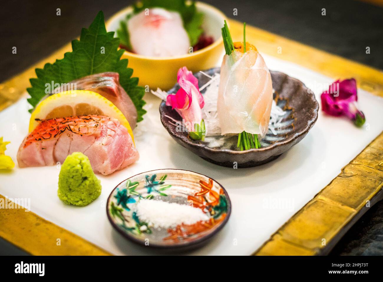 a raw fish sashimi set presented on a china plate in a Japanese