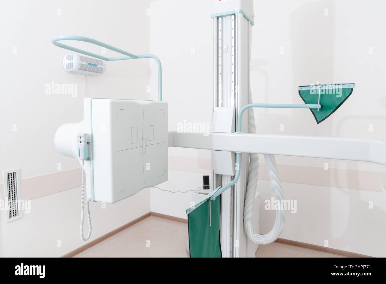 Hospital Radiology Room. X-ray department in modern hospital. Medical equipment. scan machine for fluorography. Technician adjusting an xray machine Stock Photo