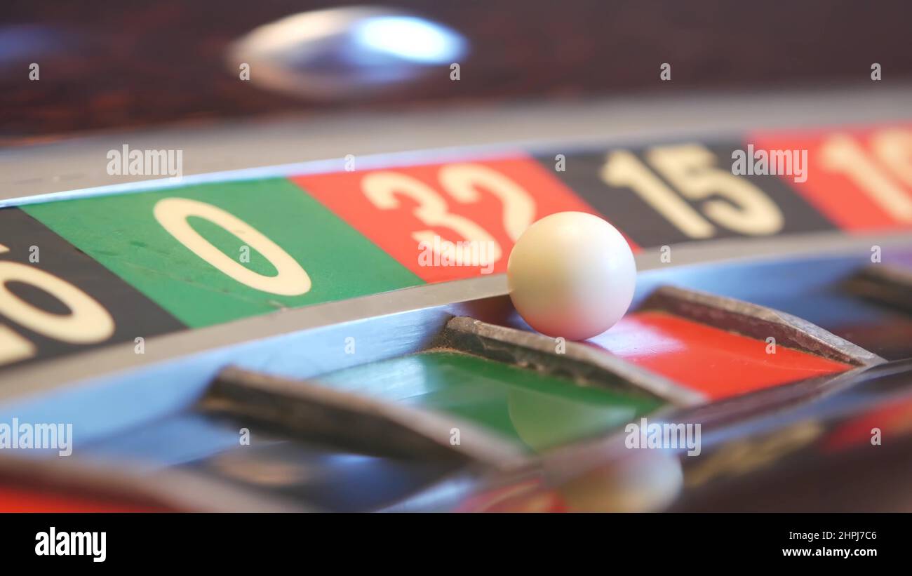 Ball on french roulette table in casino. Wheel spinning, turning or rotating. Odd and even numbers, black, red and zero sectors. Game of chance, money playing, gambling. Seamless looped cinemagraph. Stock Photo