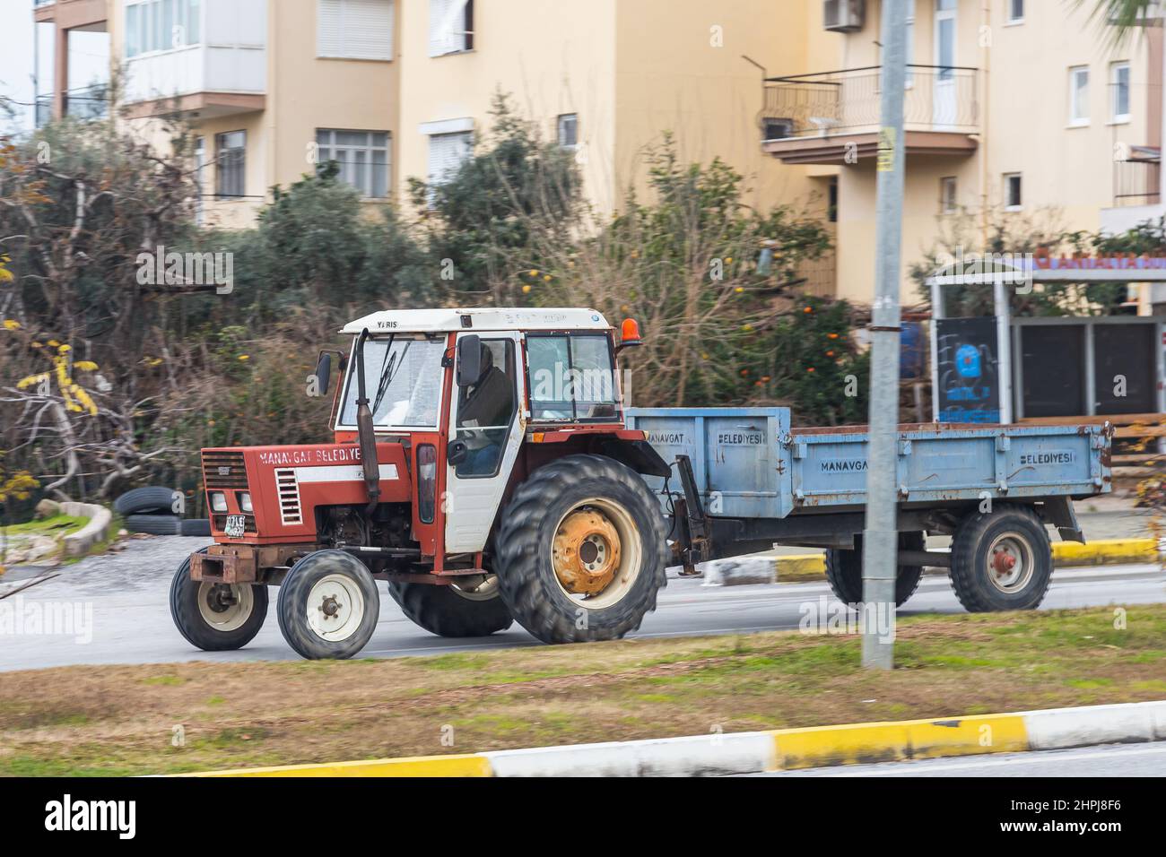 Side; Turkey – February 01 2022: man worker tractor driver rides his ...