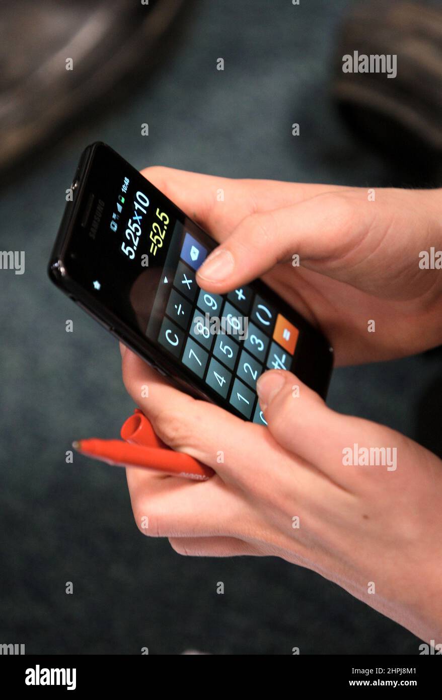 A file photo dated 26/01/12 of a pupil in an economics class using their mobile phone calculator. Four in 10 (40%) people do not feel confident about using numbers in their everyday lives, a survey has found. Issue date: Tuesday February 22, 2022. Stock Photo