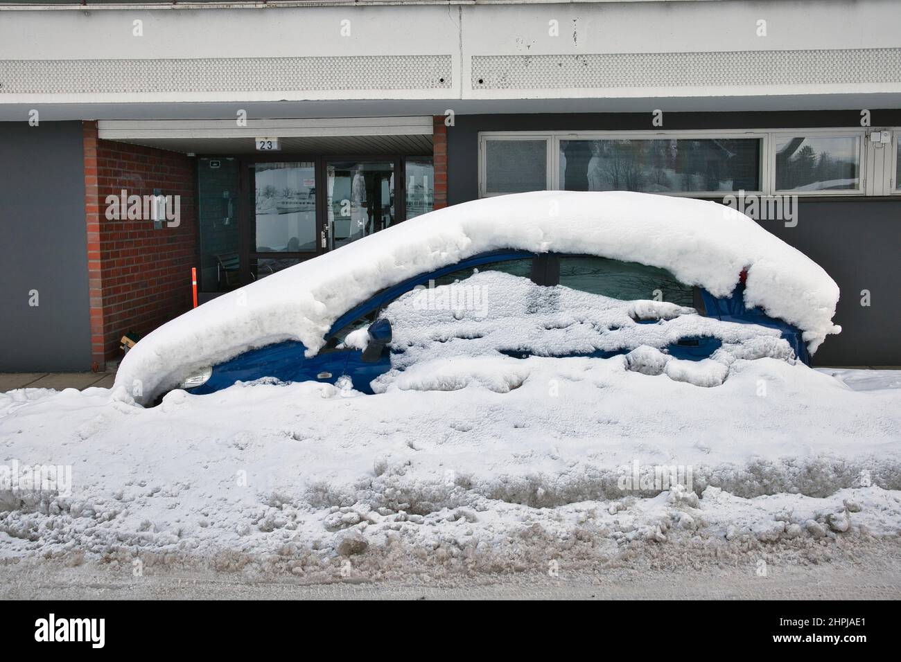 car covered in snow parked on the street, Lappeenranta Finland Stock Photo