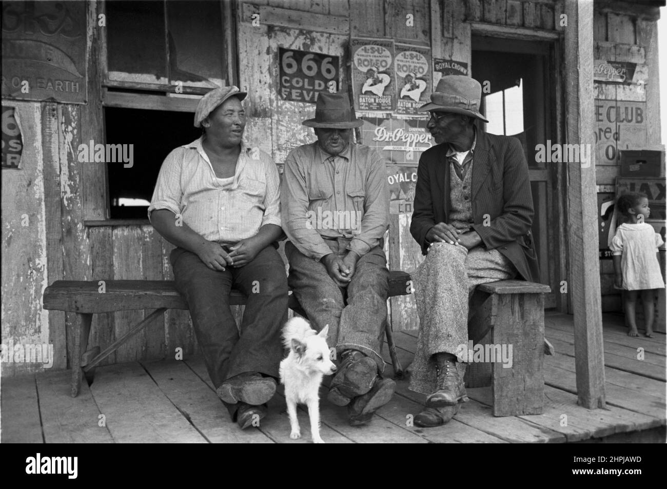 Russell Lee - African American talking on porch of small store near Jeanerette, Louisiana - 1938 Stock Photo