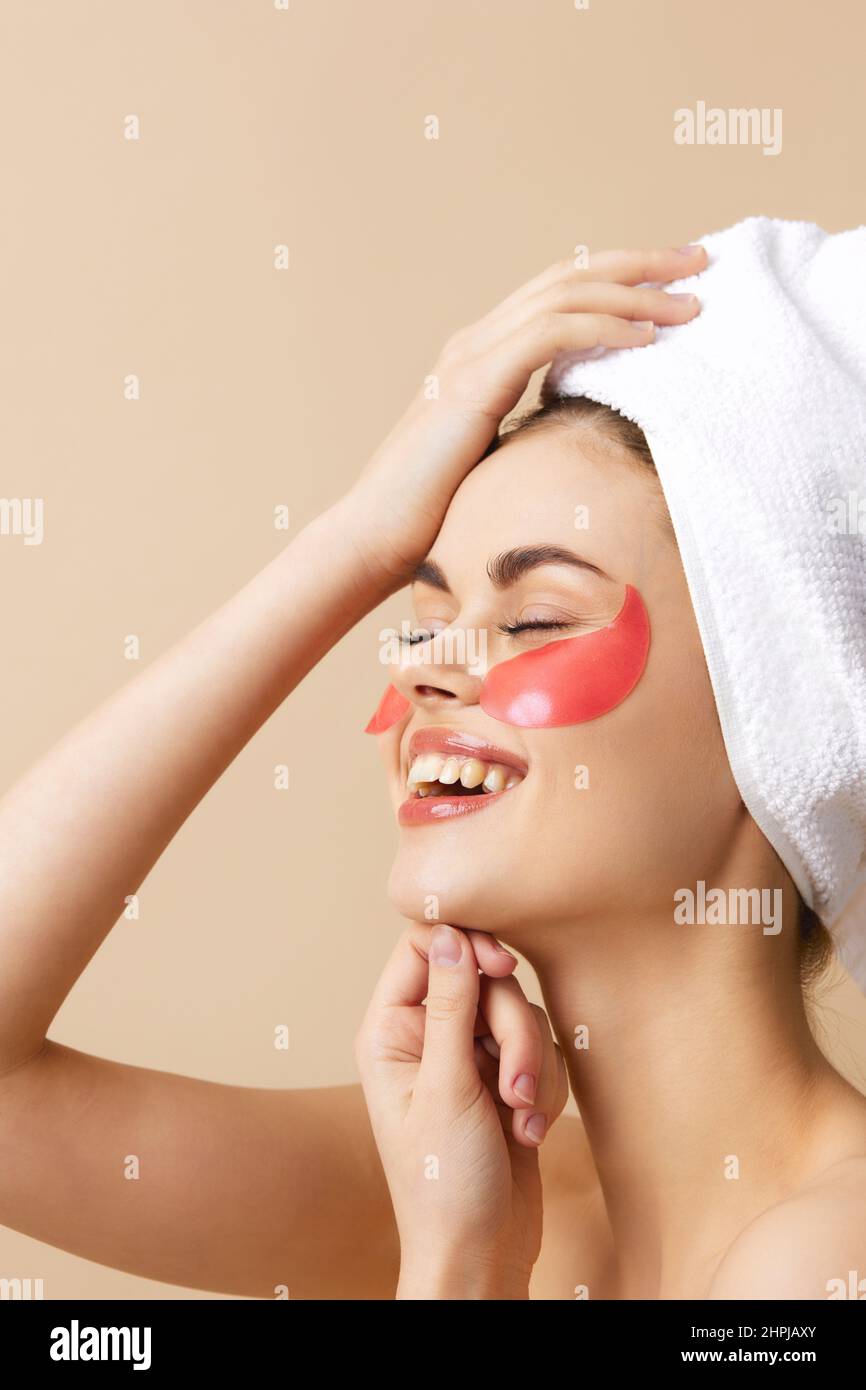 beautiful-woman-pink-patches-on-the-face-with-a-towel-on-the-head-beige