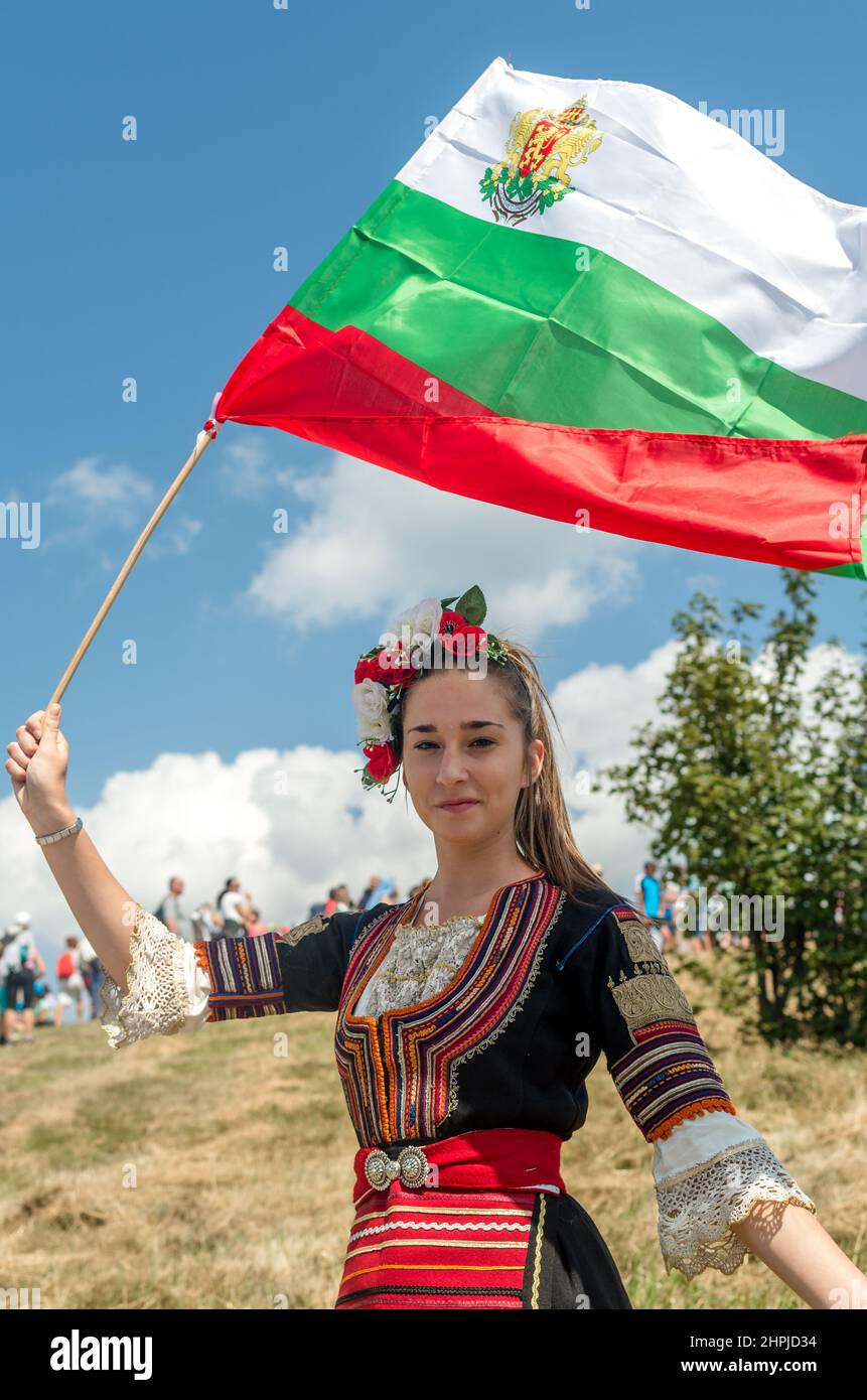 National costume waving the flag of bulgaria shipka hi-res stock