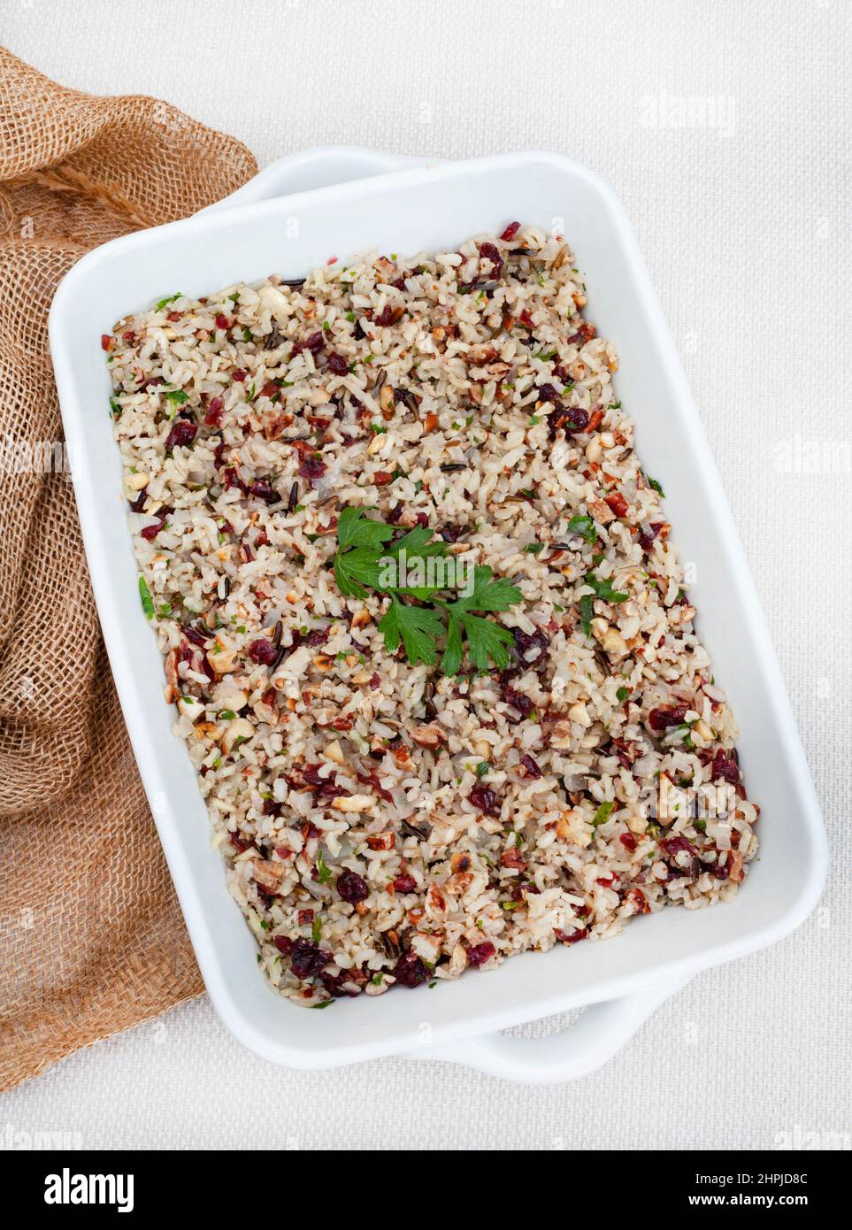 wild rice pilaf with cranberries and pecan nuts on rustic surface with