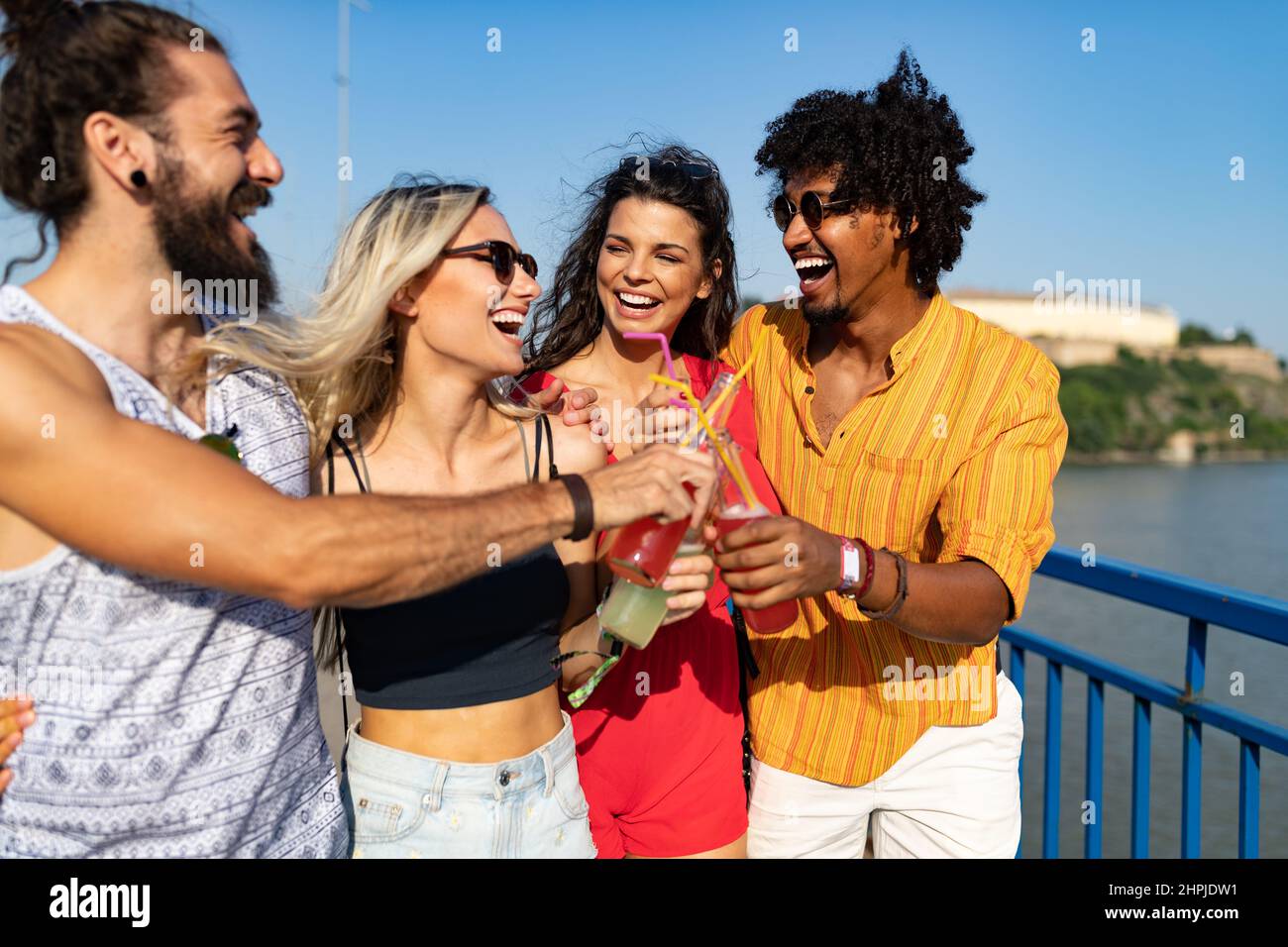 Group of happy friends hanging out and enjoying drinks, festival Stock Photo