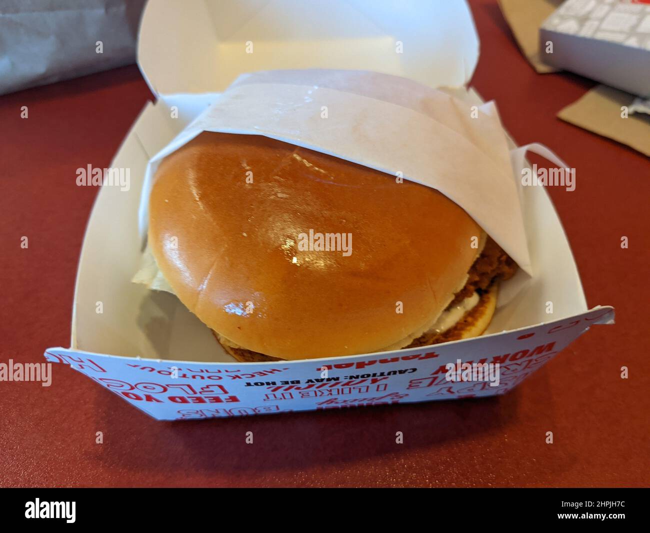 Burger in a fast food restaurant (Spicy Cluck Deluxe at Jack in the Box) Stock Photo