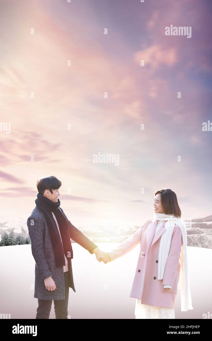 Asian Korean couple in snowing winter background Stock Photo