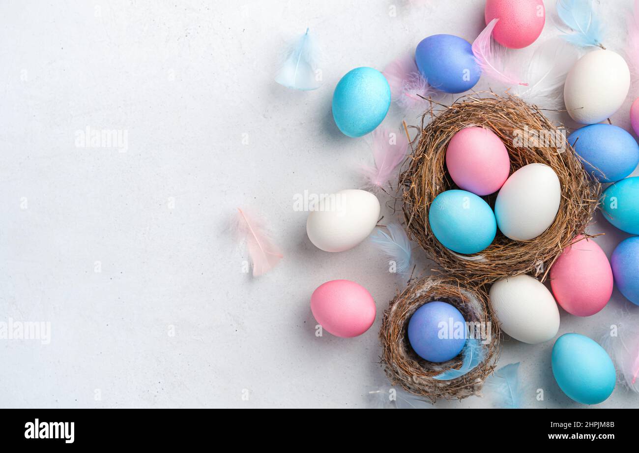 Festive background with Easter eggs on a gray background. Top view. Happy Easter. Stock Photo