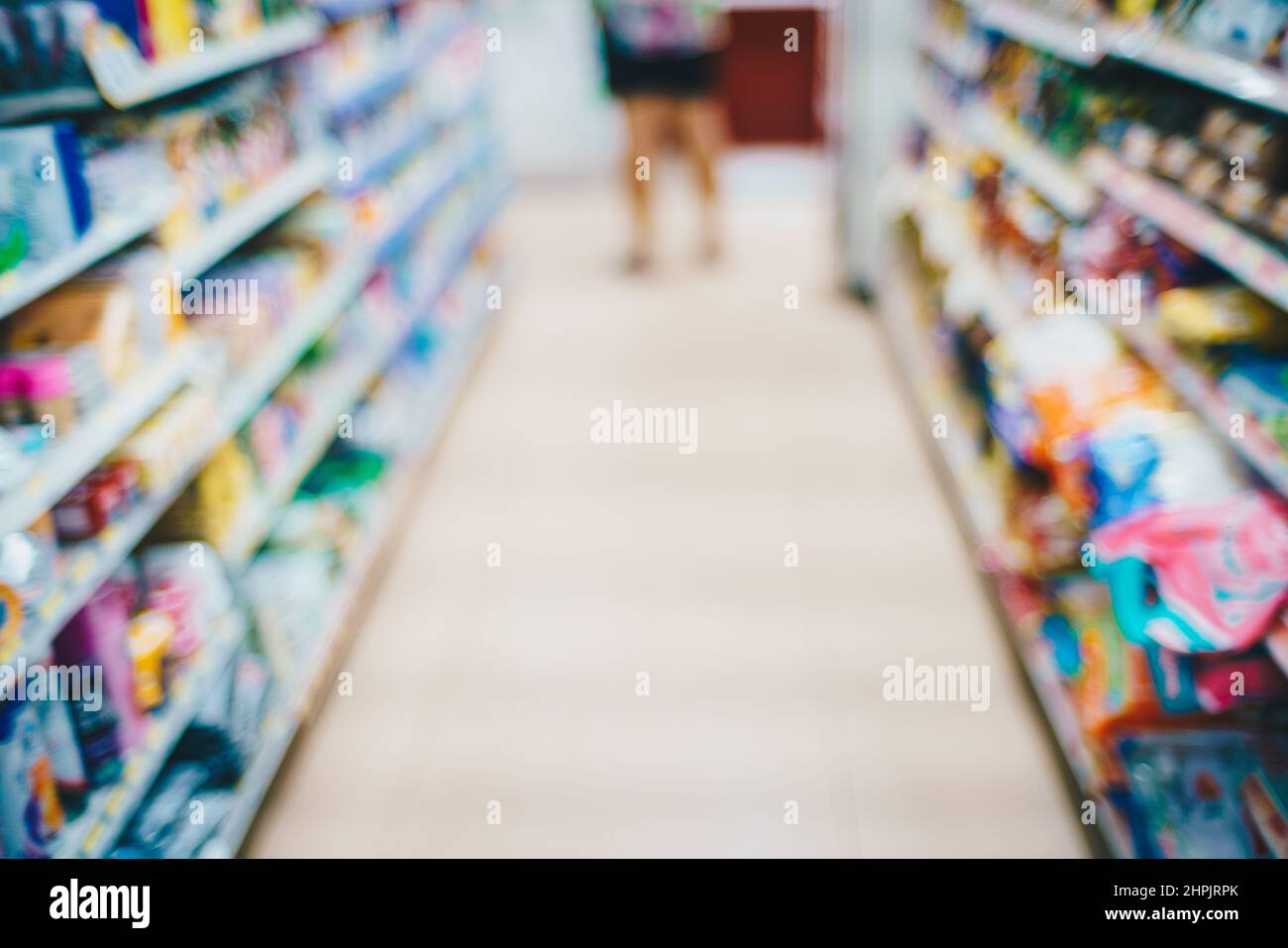 Abstract blurred row of goods on shelf in supermarket, Business
