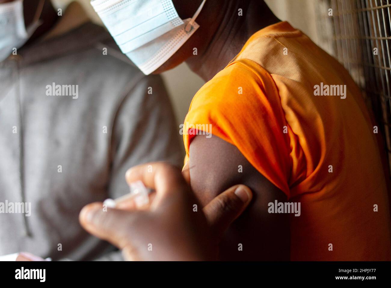 A health worker injects a patient with a Covid-19 vaccine in Lilongwe, Malawi. Stock Photo