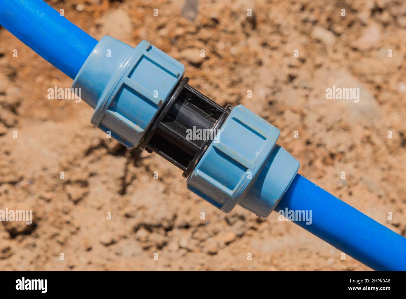 Installation and quick-disconnect connection of polyethylene water pipes of water supply. Stock Photo