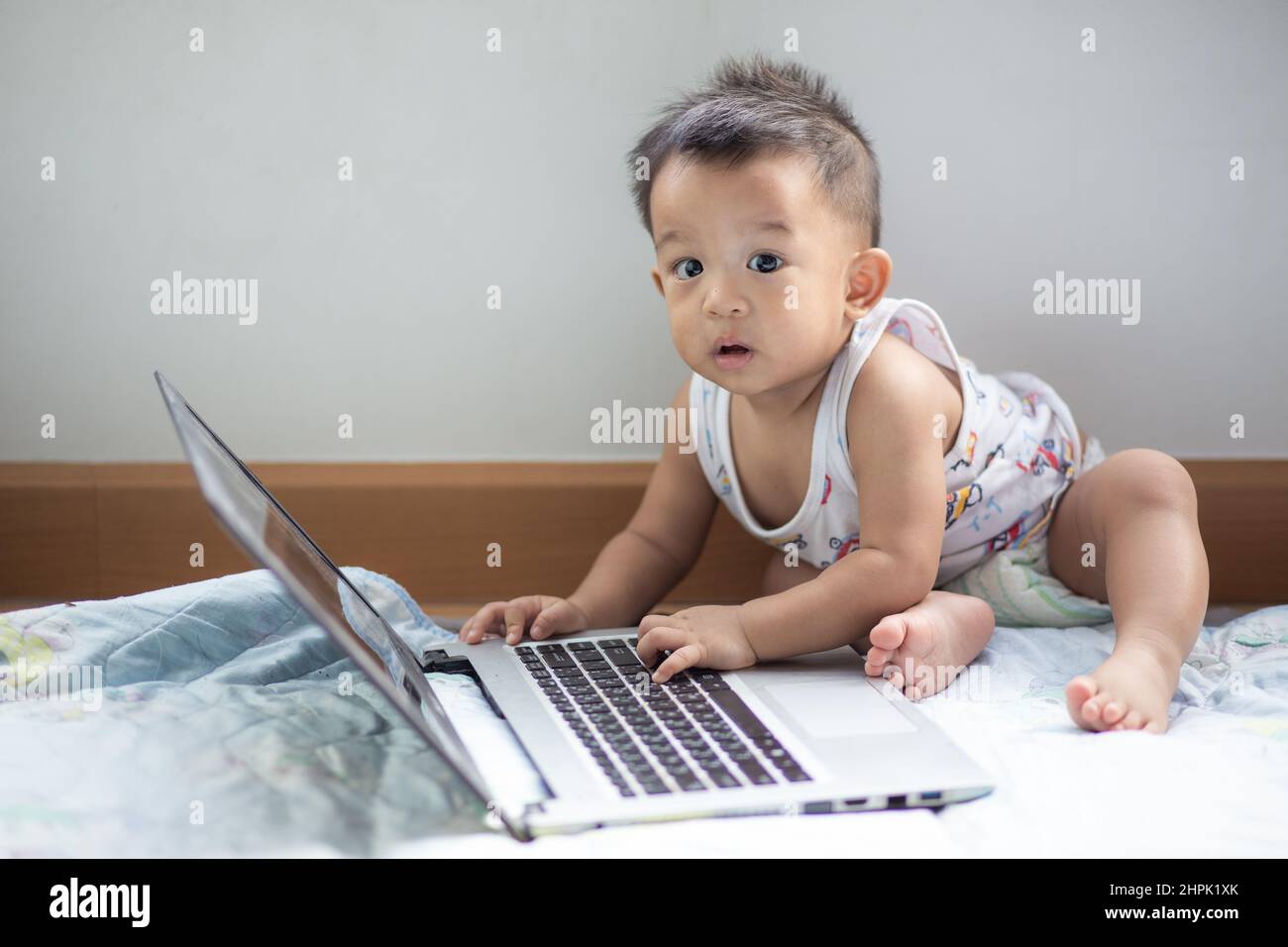 Cute asian baby boy playing laptop computer funny boy with computer ...