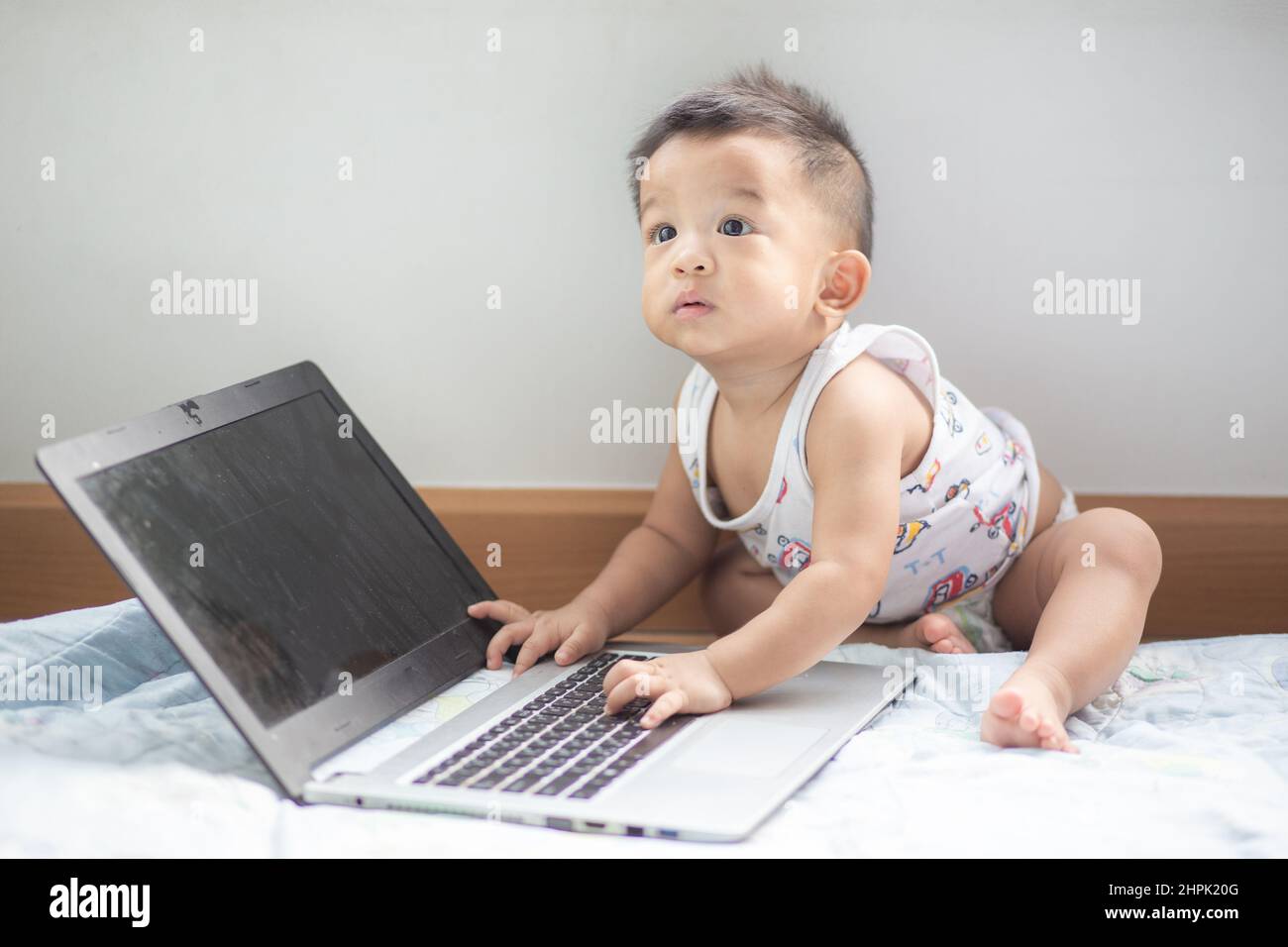 Cute asian baby boy playing laptop computer funny boy with computer ...