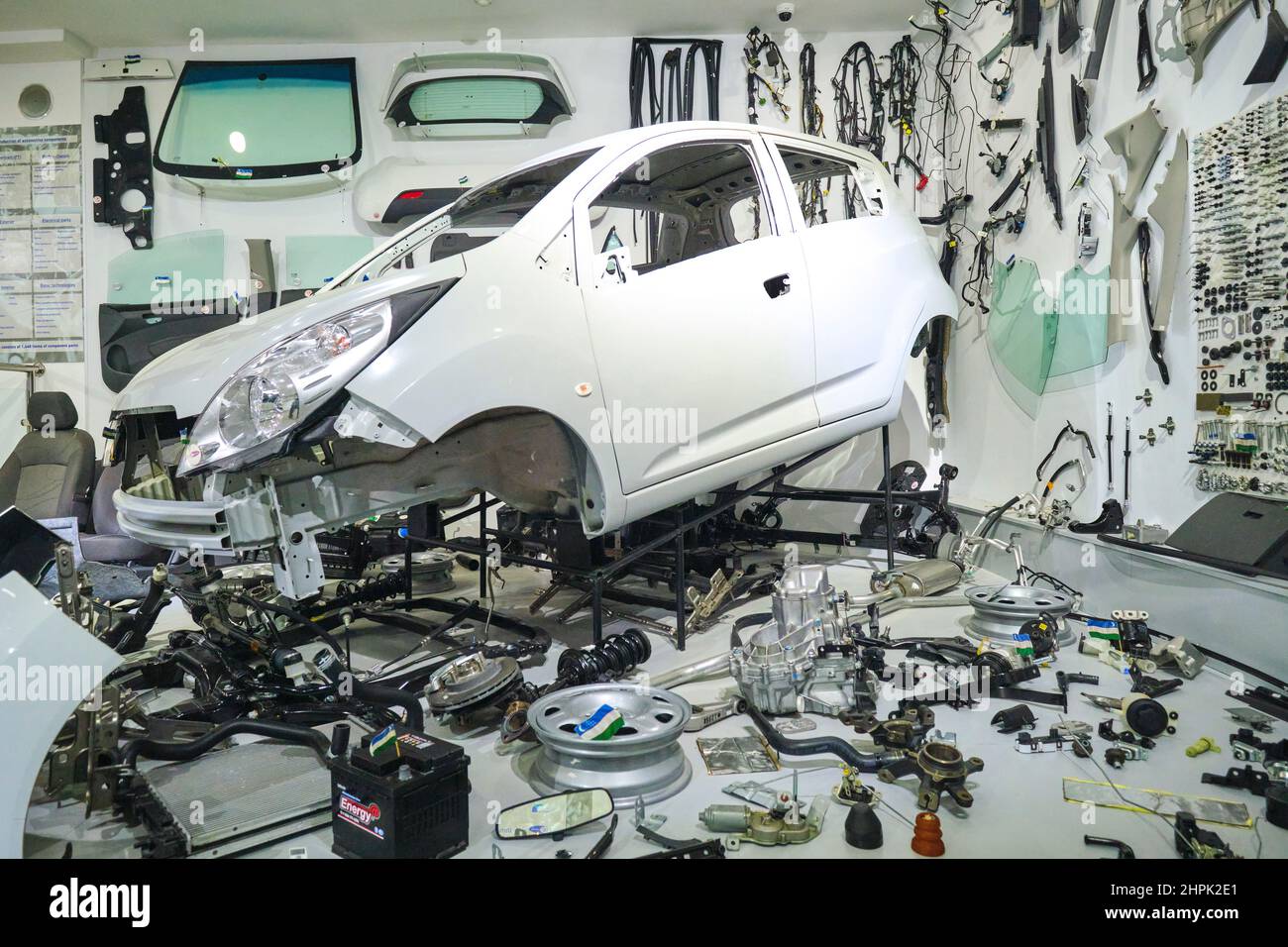 A look at a white Chevrolet Spark, taken apart to show all of its parts. Made at a local factory in Uzbekistan. At the Polytechnical, Polytexnika Tran Stock Photo