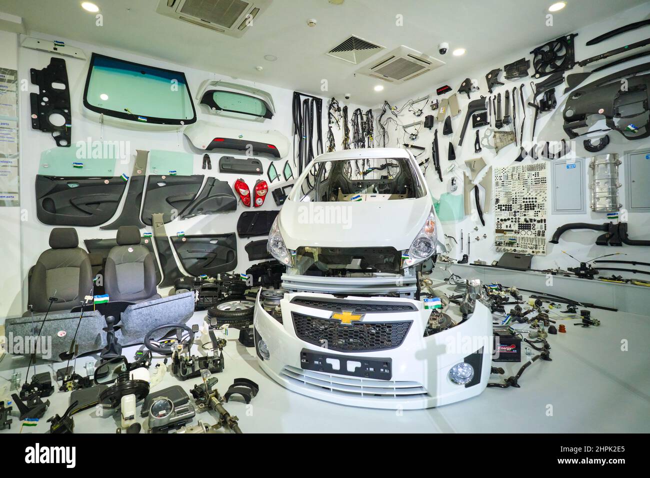 A look at a white Chevrolet Spark, taken apart to show all of its parts. Made at a local factory in Uzbekistan. At the Polytechnical, Polytexnika Tran Stock Photo