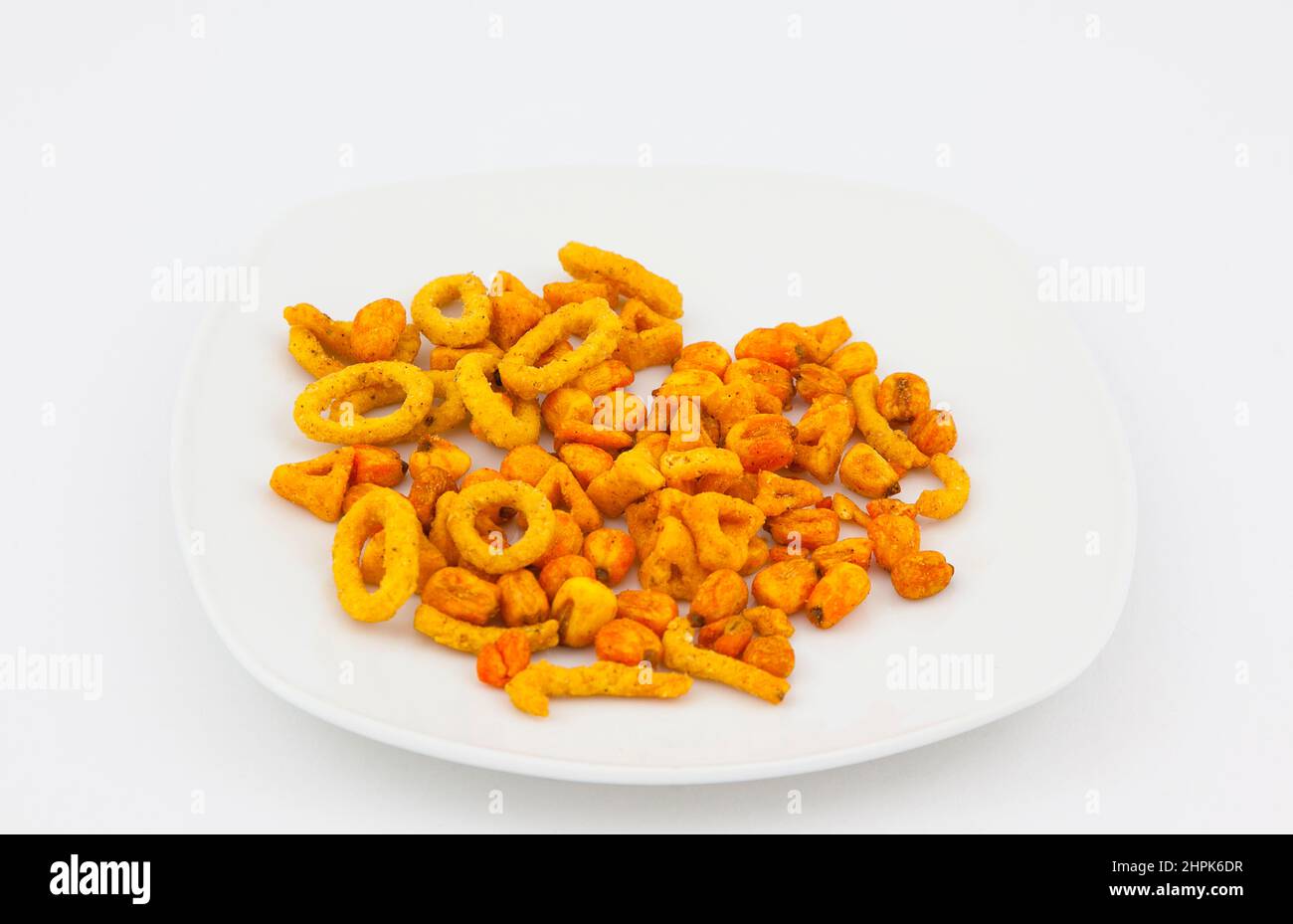 Food, Snacks, Spicy flavoured baked corn shapes. Stock Photo