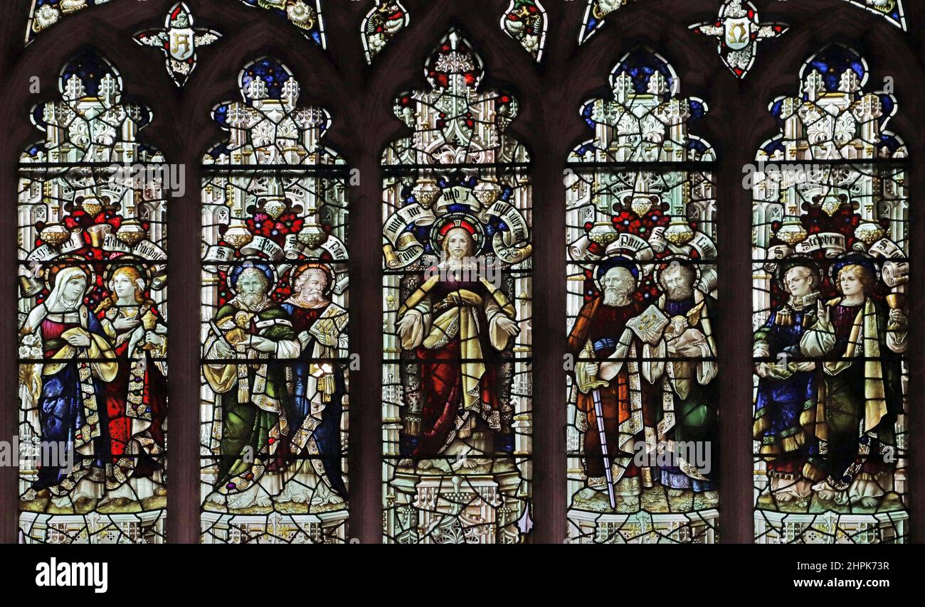 Stained glass window by Percy Bacon & Brothers depicting various saints, and Christ Consoler; St. Peter and St. Paul's Church, Watlington, Norfolk Stock Photo