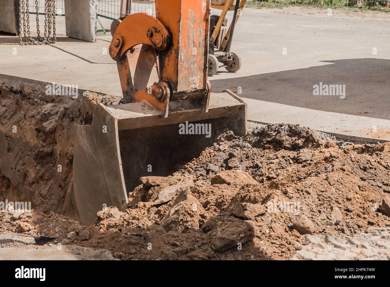 Excavation works. Tractor bucket digging with a heavy shovel on the