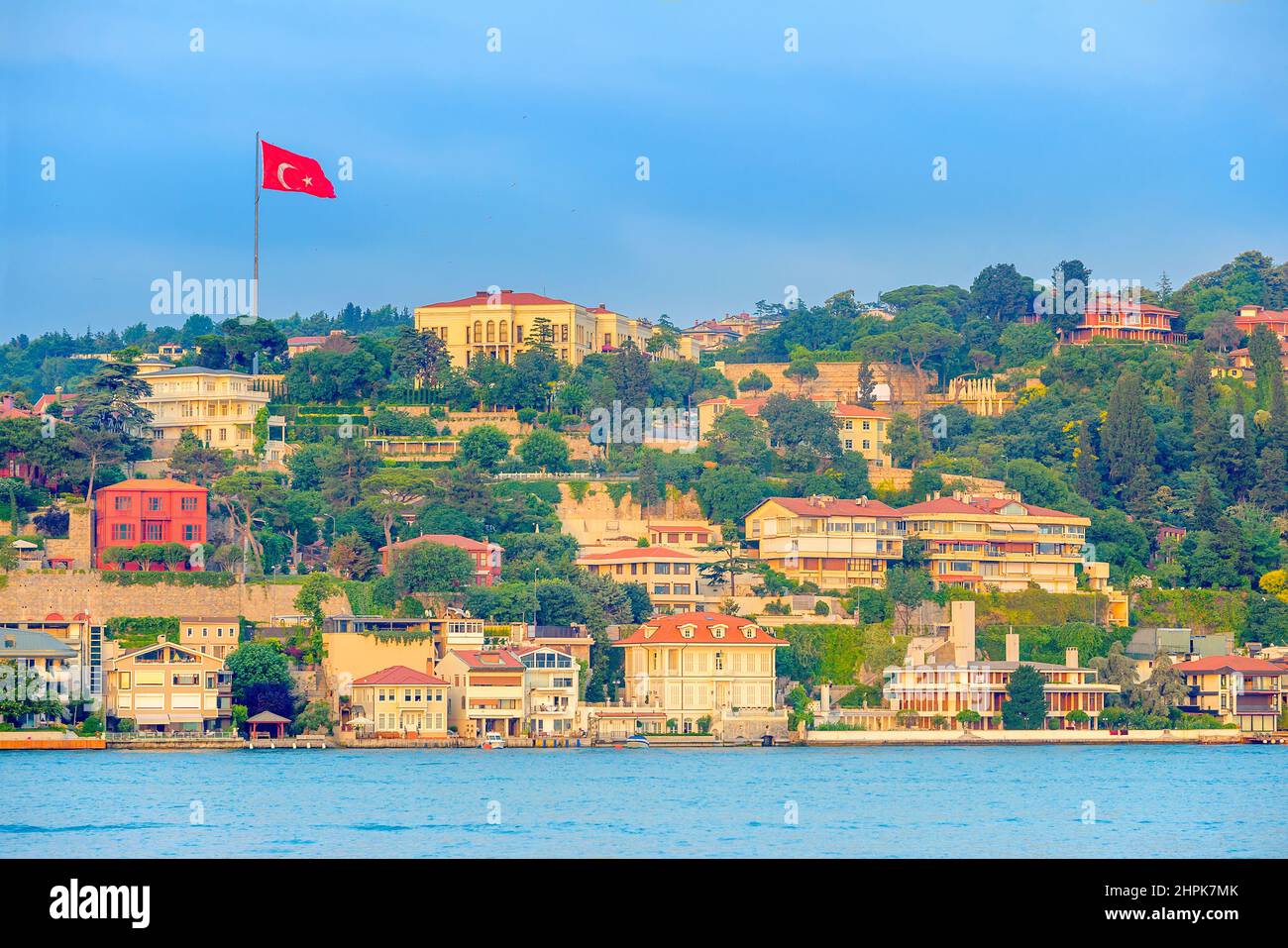 view of Istanbul from the Bosphorus Strait, the Turkish flag develops over the buildings Stock Photo