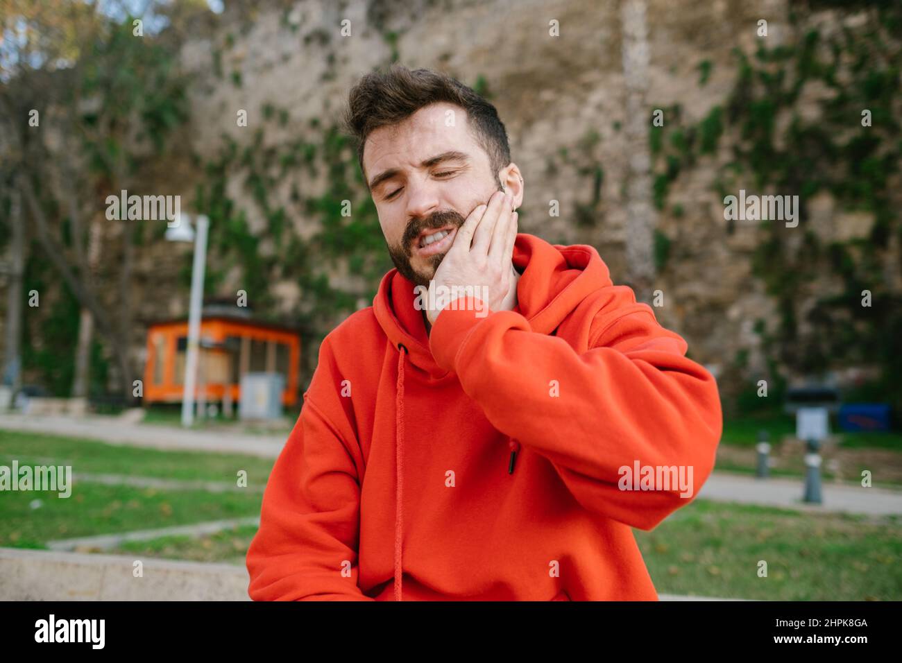 Toothache, feel terrible toothache after drink cold water. Touching cheek, feel hurt and