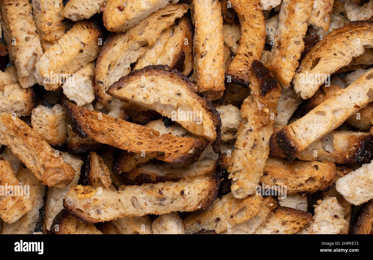 Rye bread fried croutons with garlic as background. Close up view. Stock Photo