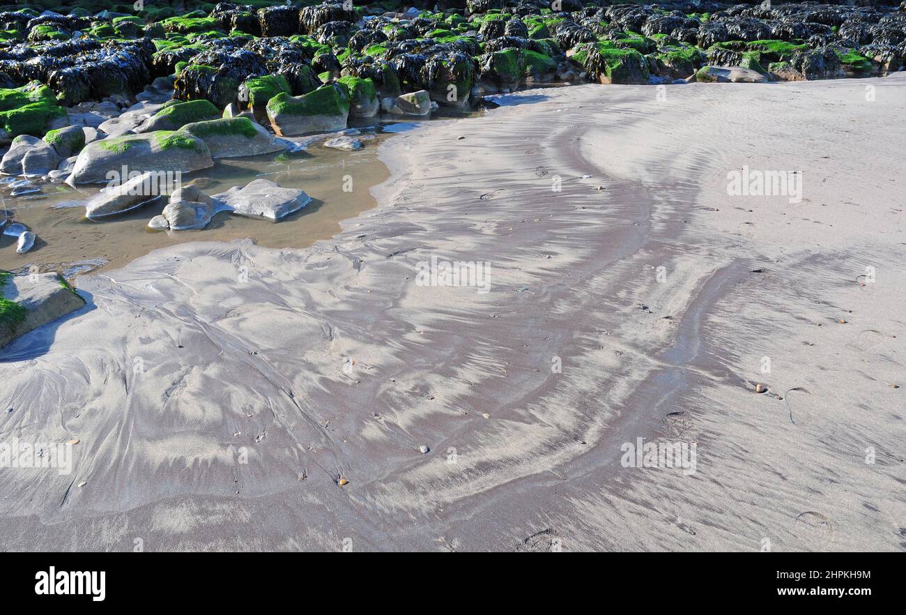 Different coloured sand and rock pools, Whitby Beach, Yorkshire. Stock Photo