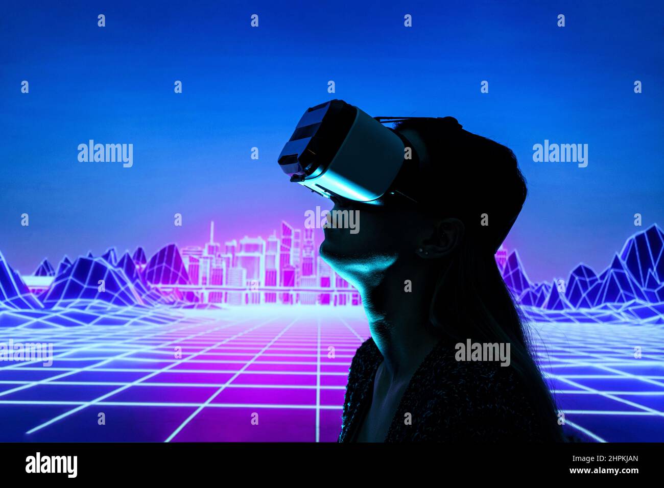 Female person using Virtual reality headset in metaverse universe. Experiencing virtual reality internet metaverse Stock Photo