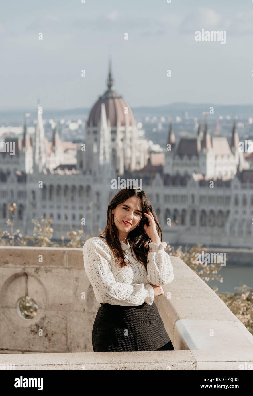 Portrait of a beautiful female on lookout point over the city of