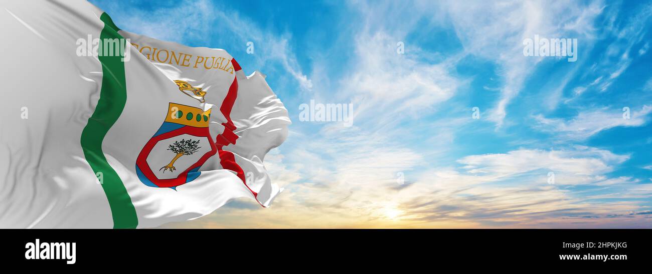 Puglia Rflag flag of Apulia, Italy at cloudy sky background on sunset, panoramic ...