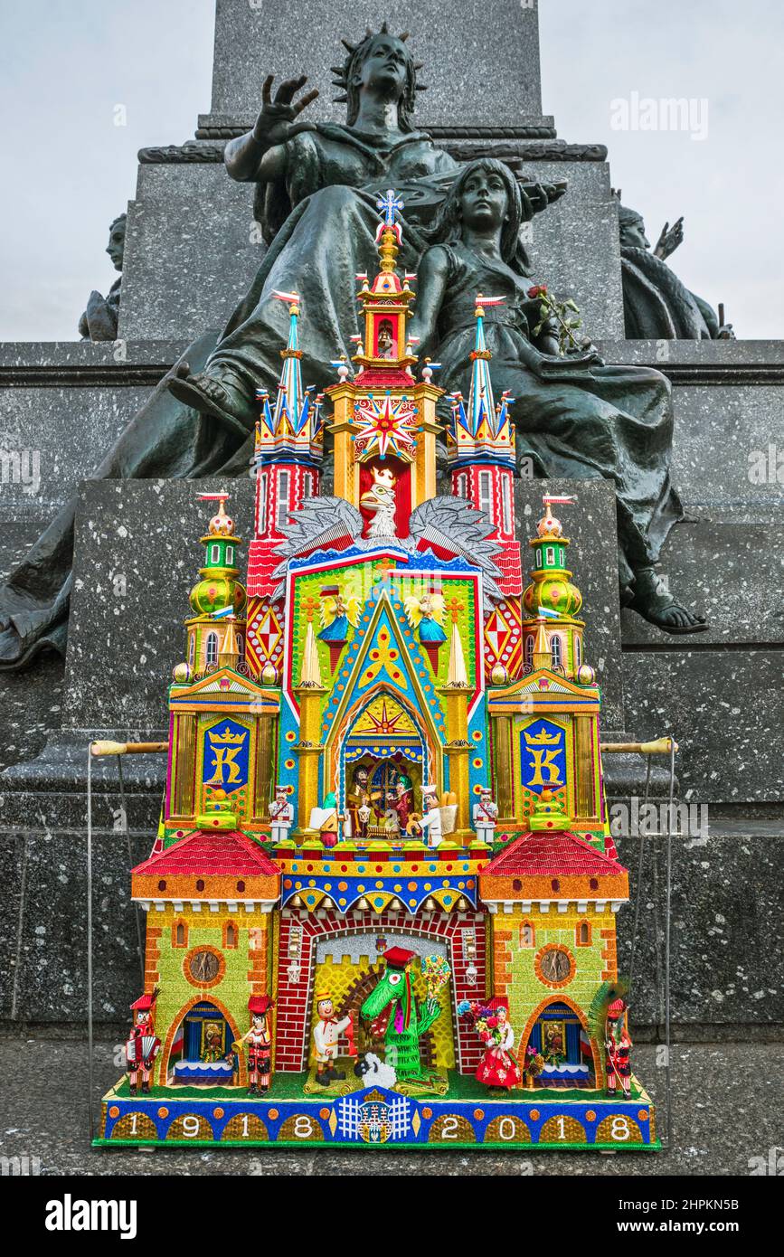 Kraków Szopka (nativity scene) displayed during annual contest in December, event included in UNESCO Cultural Heritage list, Muse of Poetry with child figures behind, at Adam Mickiewicz monument, Main Market Square, Kraków, Poland Stock Photo