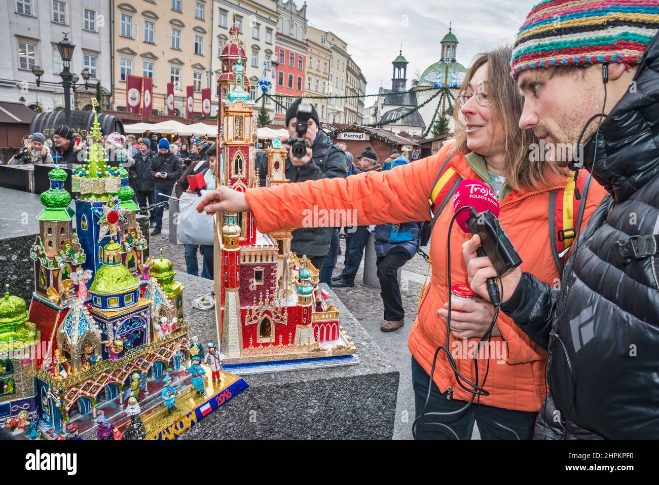 Radio reporter interviewing, Kraków Szopka nativity scenes displayed during annual contest in December, event included in UNESCO Cultural Heritage list, at Adam Mickiewicz monument, Main Market Square, Kraków, Poland Stock Photo