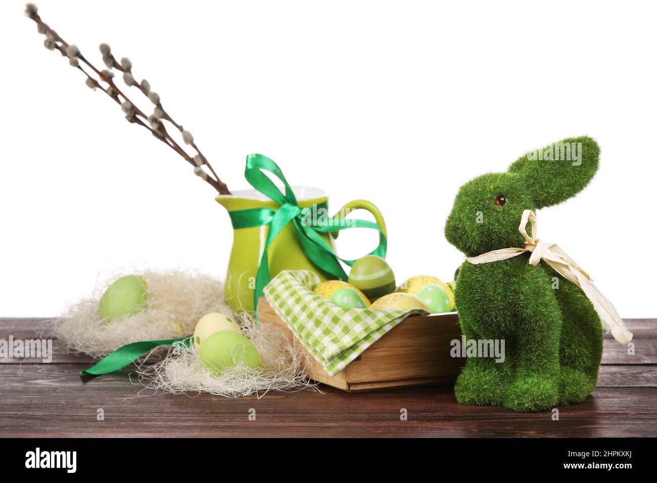 Box with painted Easter eggs, willow branches and rabbit on wooden ...