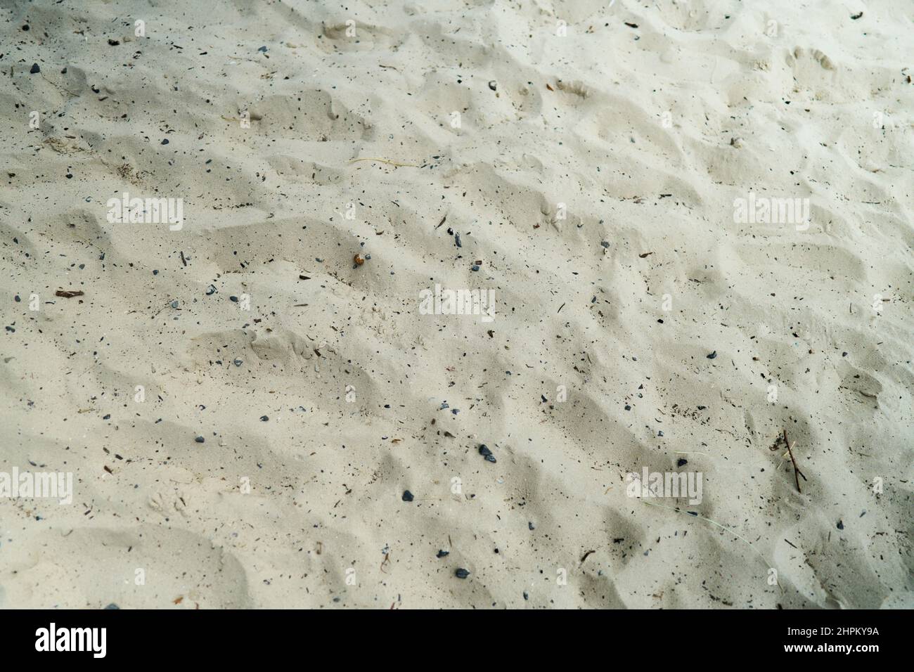 Scenic view of white sand on the beach with tiny rocks Stock Photo - Alamy