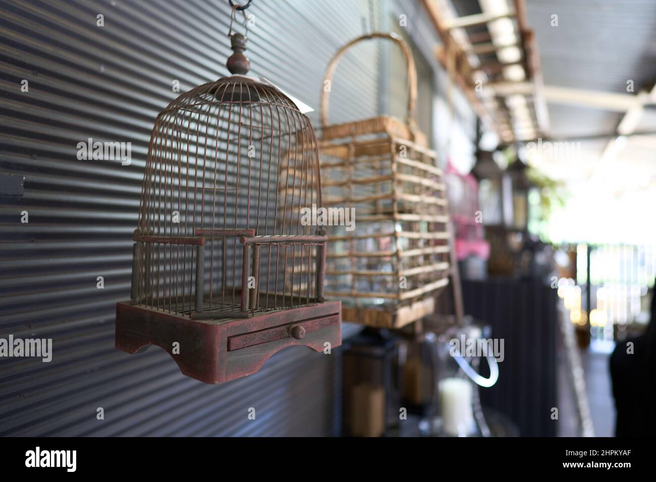 Old Metal Bird Cage Hanging Outdoors Next To A Wooden Photo Inspiration