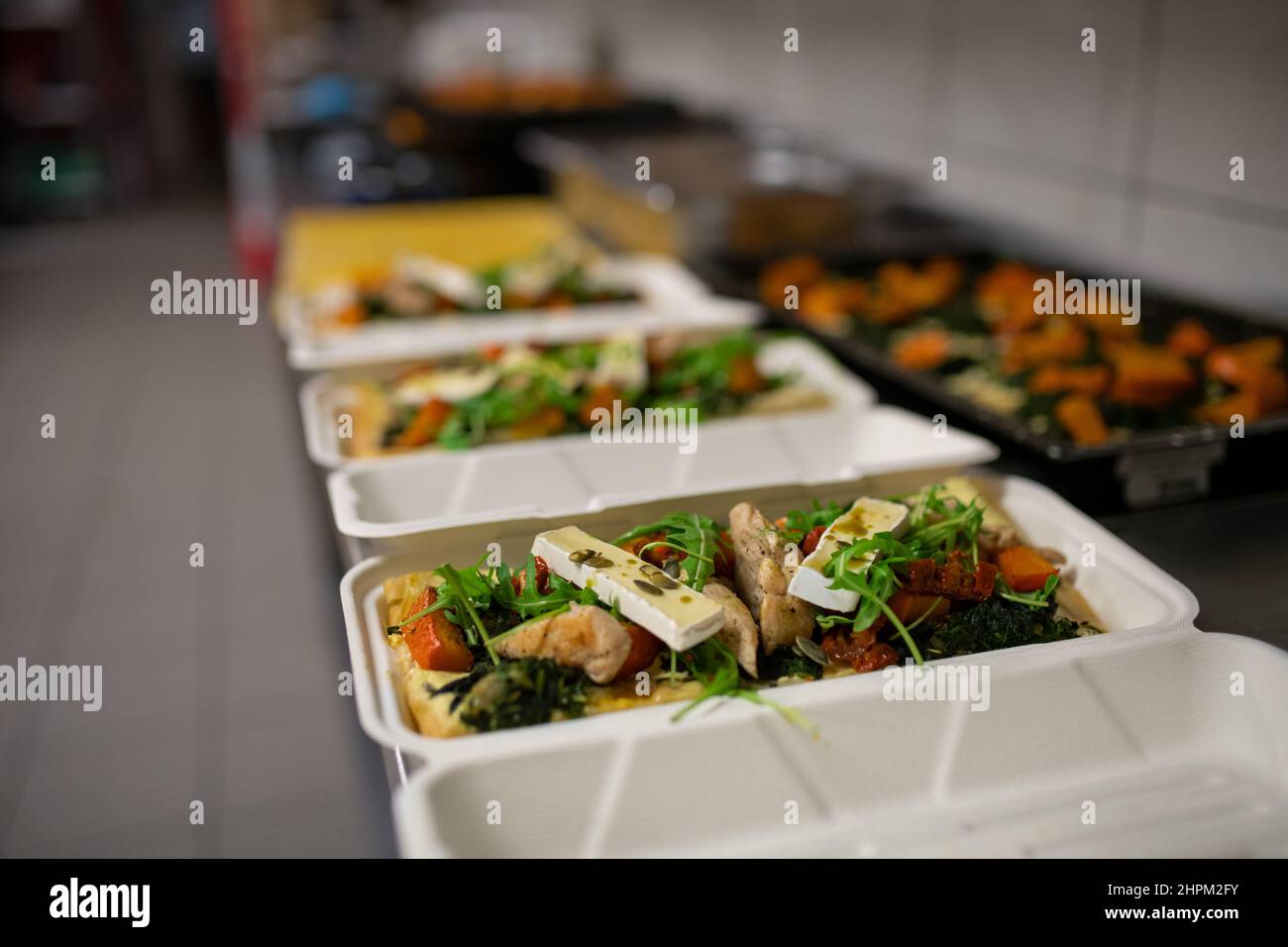 Meals in containers prepared for take away in kitchen restaurant Stock Photo Alamy