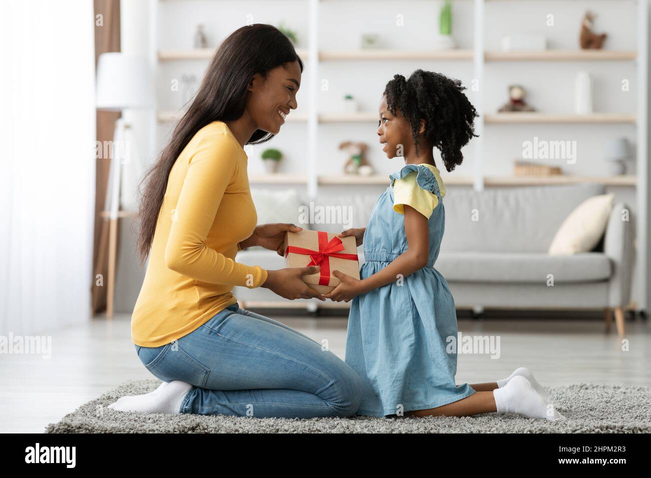 https://c8.alamy.com/comp/2HPM2R3/excited-black-woman-receiving-present-for-mothers-day-from-her-little-daughter-2HPM2R3.jpg